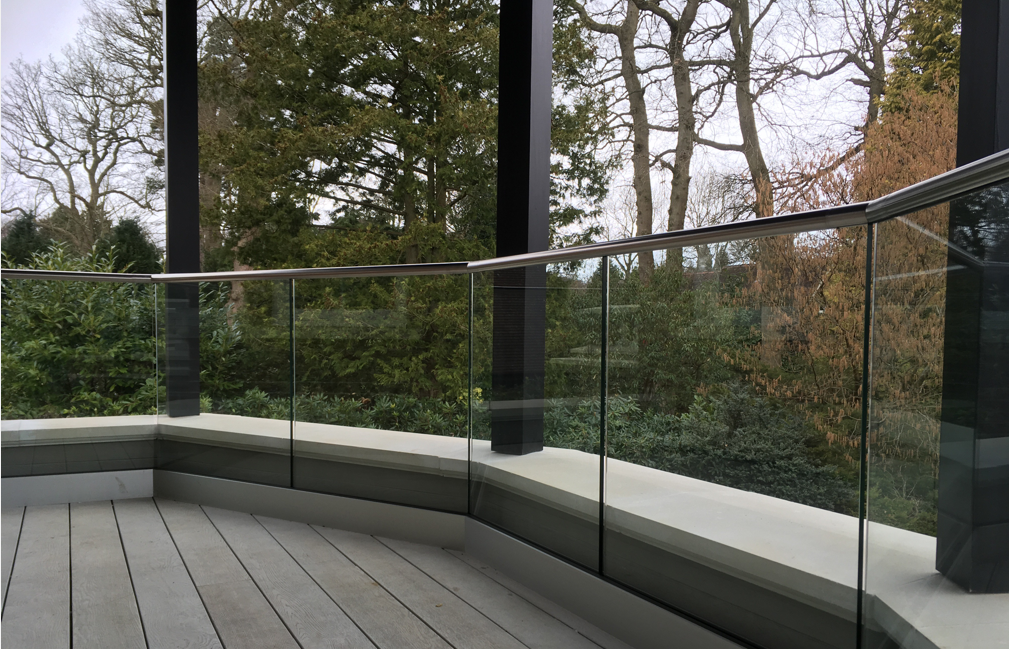 Frameless Glass balustrade with angled handrail without posts by