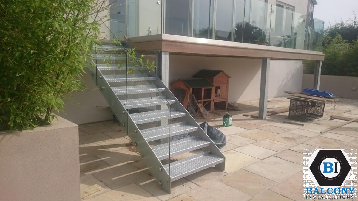 Balcony Installations - frameless laminated glass on steel stairs and decking