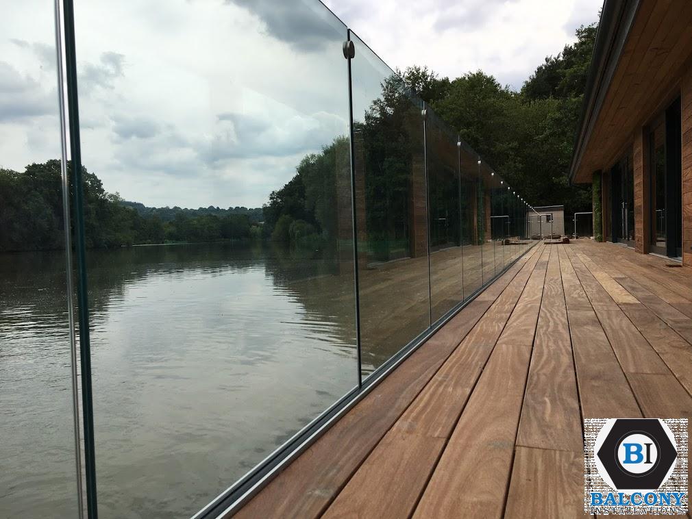 frameless with glass connectors on decking by lake by Balcony Installations