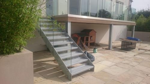 Balcony Installations - frameless laminated glass on steel stairs and decking